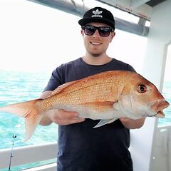 Angler with snapper on MV Koru